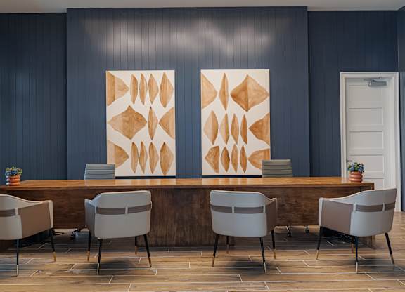 A conference room with a long table and chairs.
