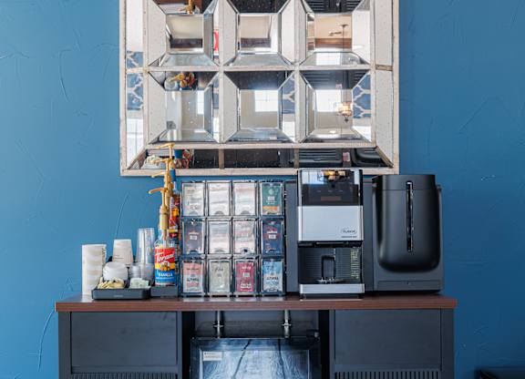 A black fridge with a large window on the front and a smaller window on the top.
