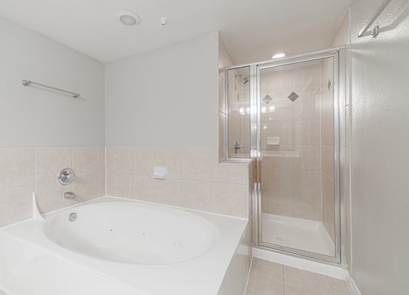 A white bathroom with a glass shower door.