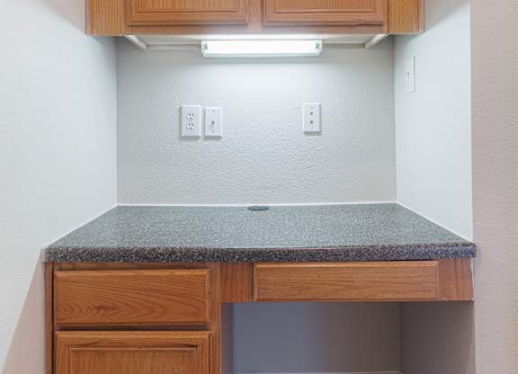 A small kitchen with a counter and cabinets.