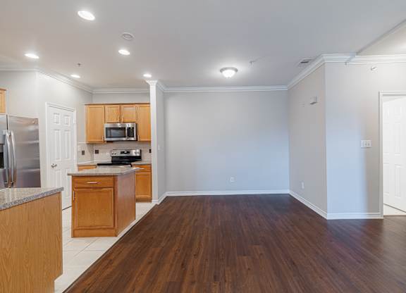 A kitchen with wooden cabinets and a refrigerator.