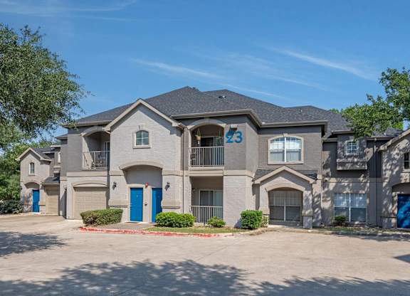 A large, modern house with the number 23 on the front.