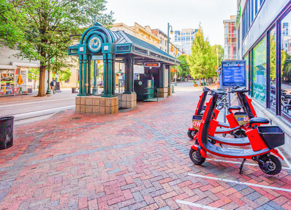 a red scooter parked in front of a store
