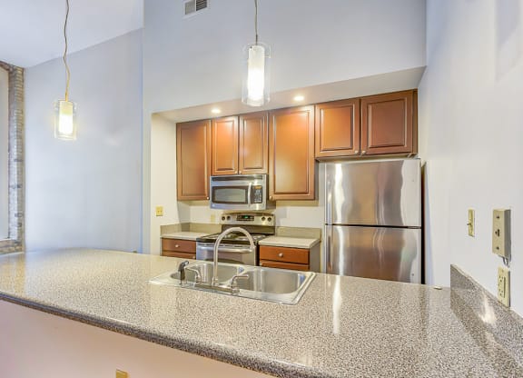 a kitchen with granite countertops and stainless steel appliances
