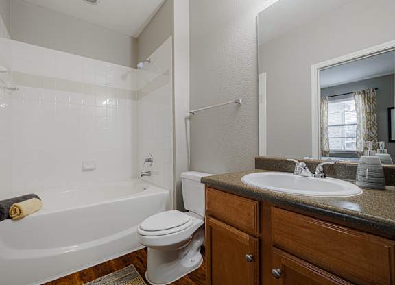 a bathroom with a sink toilet and bath tub