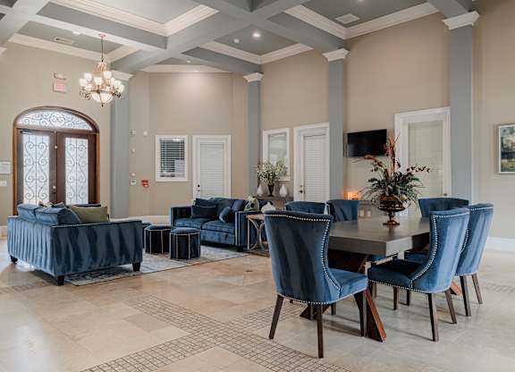 a dining room and living room with blue chairs and a table