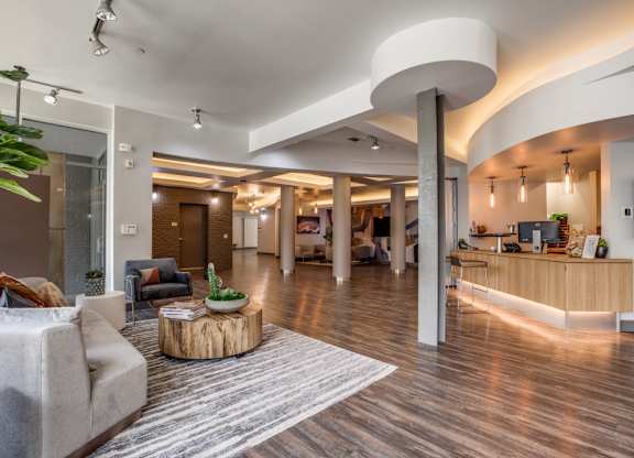 A modern living room with a grey sofa and a wooden coffee table.