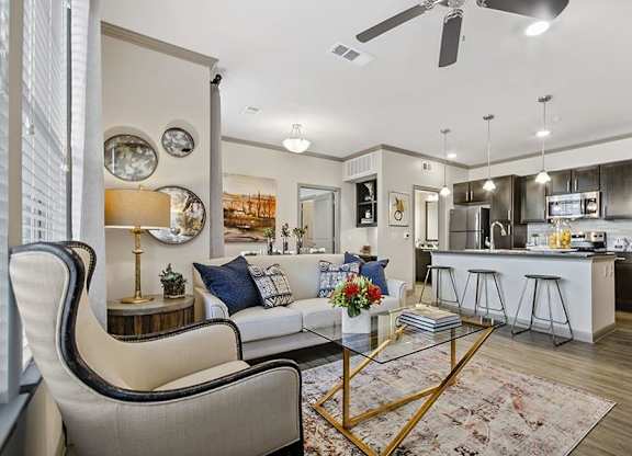 A modern living room with a white sofa and a coffee table.