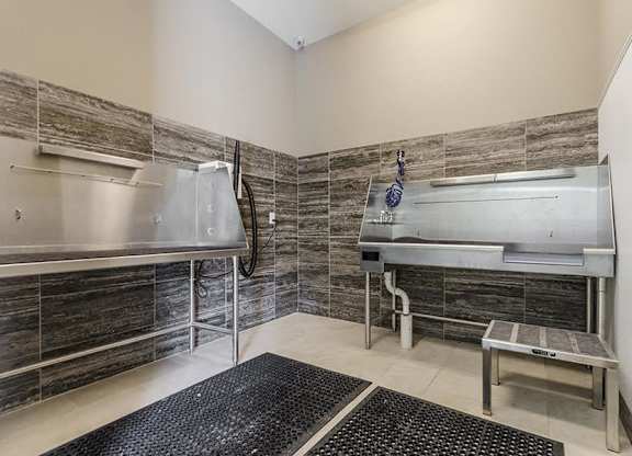 A room with a stainless steel sink and a stainless steel dryer.