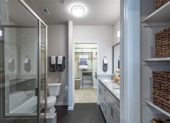 a bathroom with a shower and a toilet and a sink