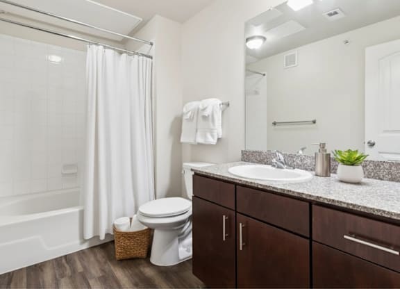 A white toilet sits next to a white sink in a bathroom.