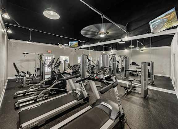 A gym with treadmills and other exercise equipment.