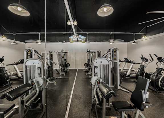 A gym with a variety of exercise equipment.