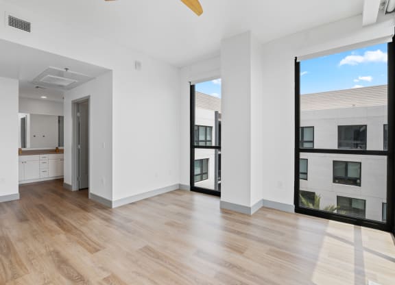 an empty room with purple and white walls and a wood floor