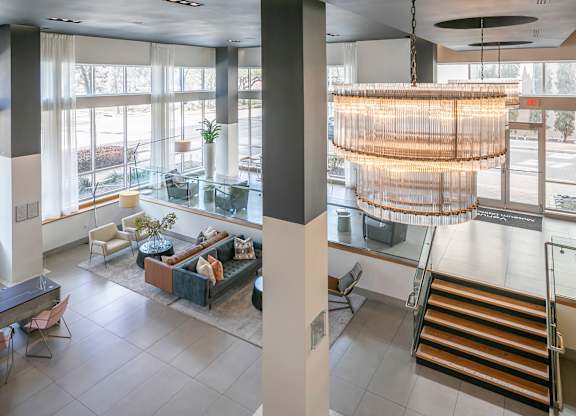 A large, open space with a hanging light fixture and a staircase.
