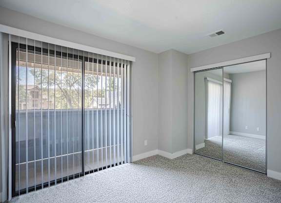 the master bedroom has sliding glass doors to the patio