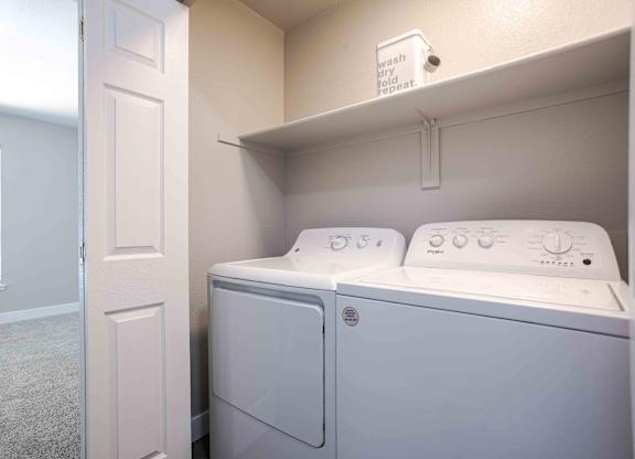 a washer and dryer in a laundry room with a closet