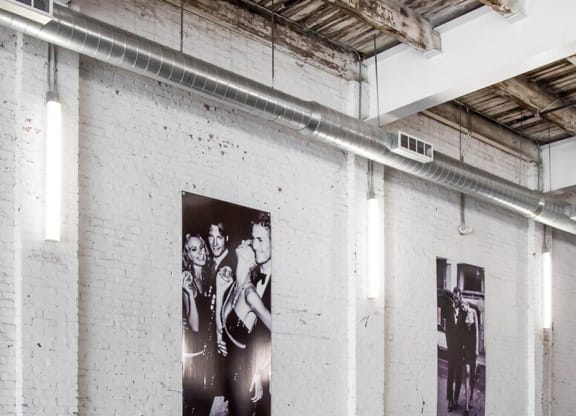 a black and white photo of the beatles on a brick wall
