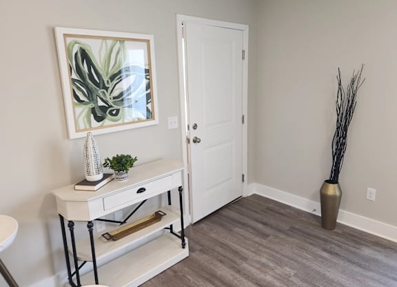 A white door is in a room with a grey floor.