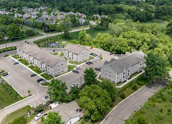 A bird's eye view of a residential area with houses and cars.
