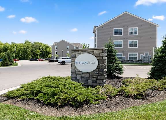 A sign that says Westlake Place in front of a building.