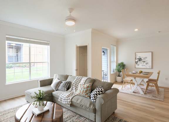 A living room with a grey couch and a coffee table.
