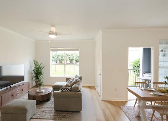 A living room with a television, couch, and a table.