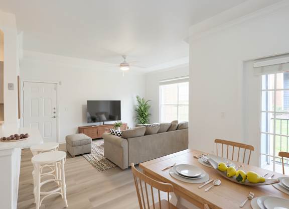 A dining room with a table set for a meal.