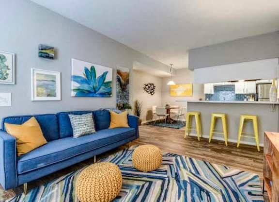 a living room with a blue couch and pillows