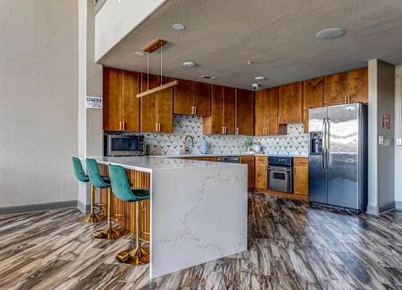 a kitchen with wooden cabinets and a white marble counter top