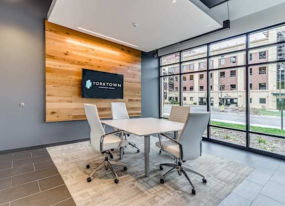 A conference room with a wooden backdrop and a Yorktown sign.