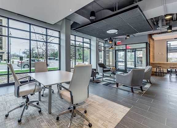 A conference room with a table and chairs.
