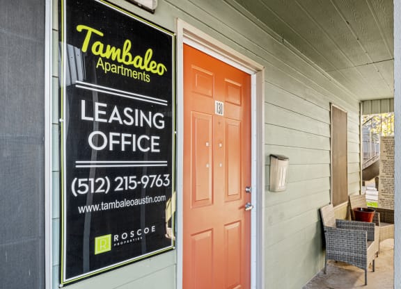 the front door of a building with a leasing office sign