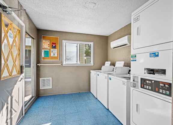 a kitchen with appliances and a window and a laundry room