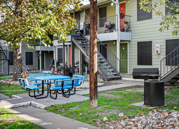 our apartments have a patio with tables and chairs