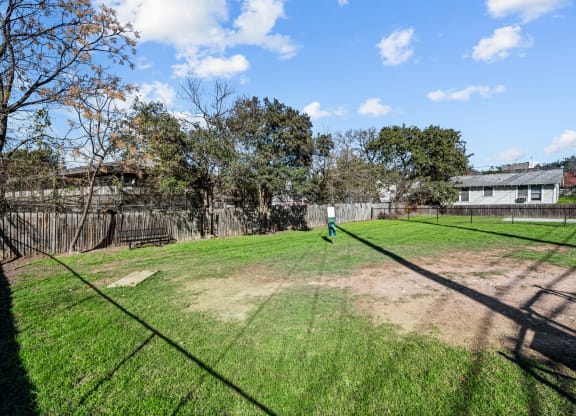 the backyard of a house with a yard and a fence