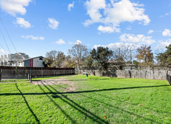 the backyard of a house with a yard and a fence