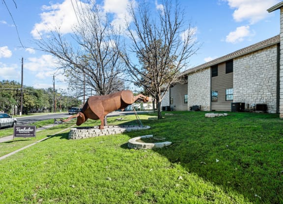 a sculpture of a horse in front of a building