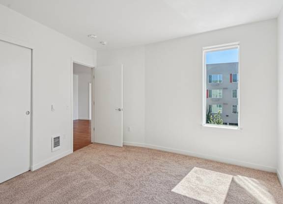 Bedroom with a window at Hana Apartments, Hillsboro
