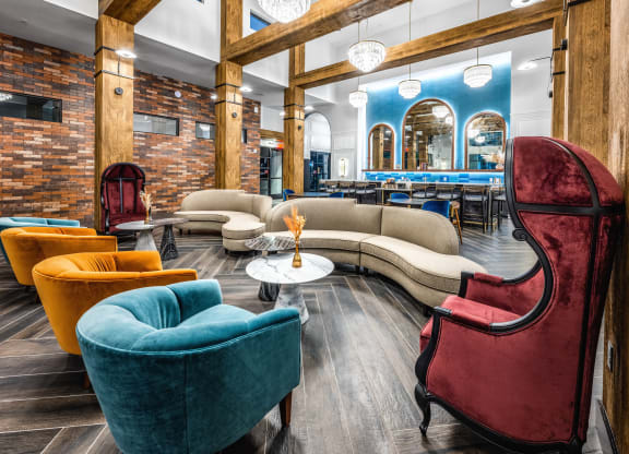 a lobby with couches and chairs and a bar at The Alibi at Lake Lilly, Ocoee, 34761