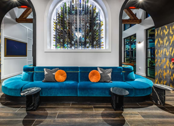 a living room with a blue couch and a large window
