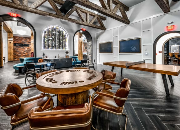 a game table in a room with chairs and tables at The Alibi at Lake Lilly, Florida, 34761