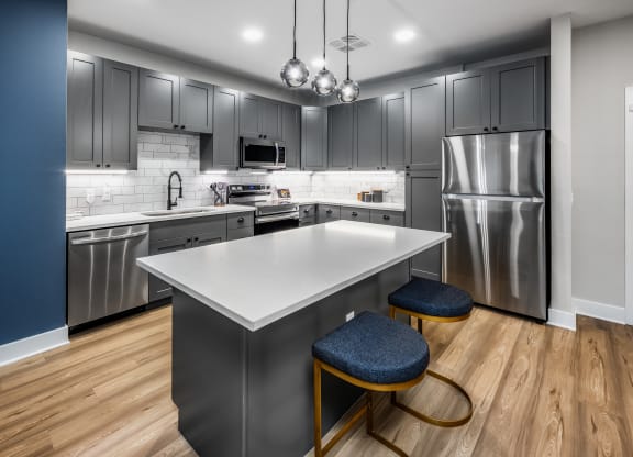 a kitchen with stainless steel appliances and a white counter top at The Alibi at Lake Lilly, Ocoee, FL