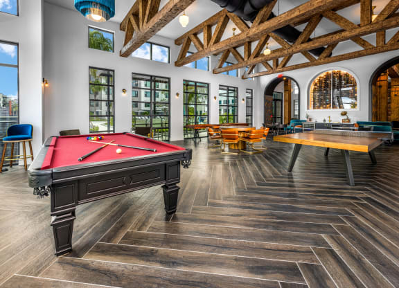 a games room with a pool table and tables at The Alibi at Lake Lilly, Ocoee, FL, 34761