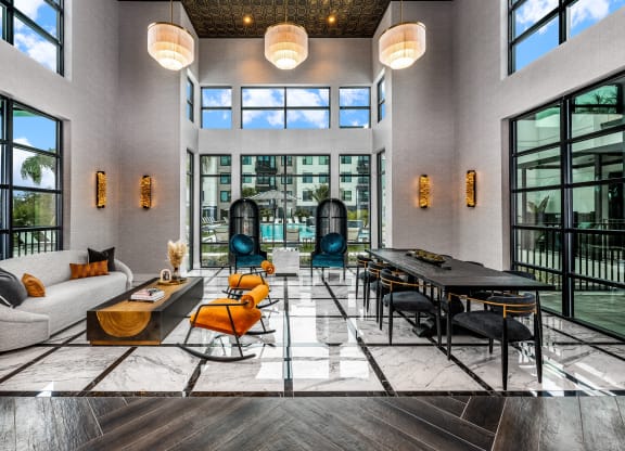 a large living room with large windows and a large table and chairs at The Alibi at Lake Lilly, Ocoee, FL, 34761