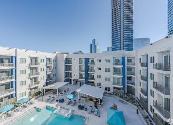 A large white building with a pool in the middle of it.