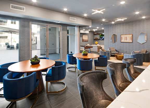 a communal area with tables and chairs in the lobby of a building at Aura Vegas Apartments, Nevada