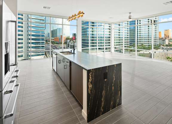 the kitchen has a large island with a view of the city at Aura Vegas Apartments, Las Vegas, Nevada