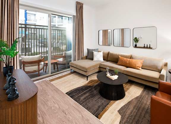 a living room with a couch and a table at Aura Vegas Apartments, Las Vegas, Nevada