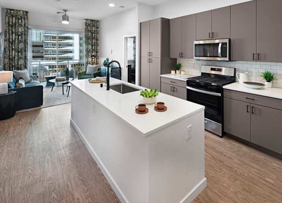 a view of a kitchen with a large island in the middle at Aura Vegas Apartments, Las Vegas, NV 89103